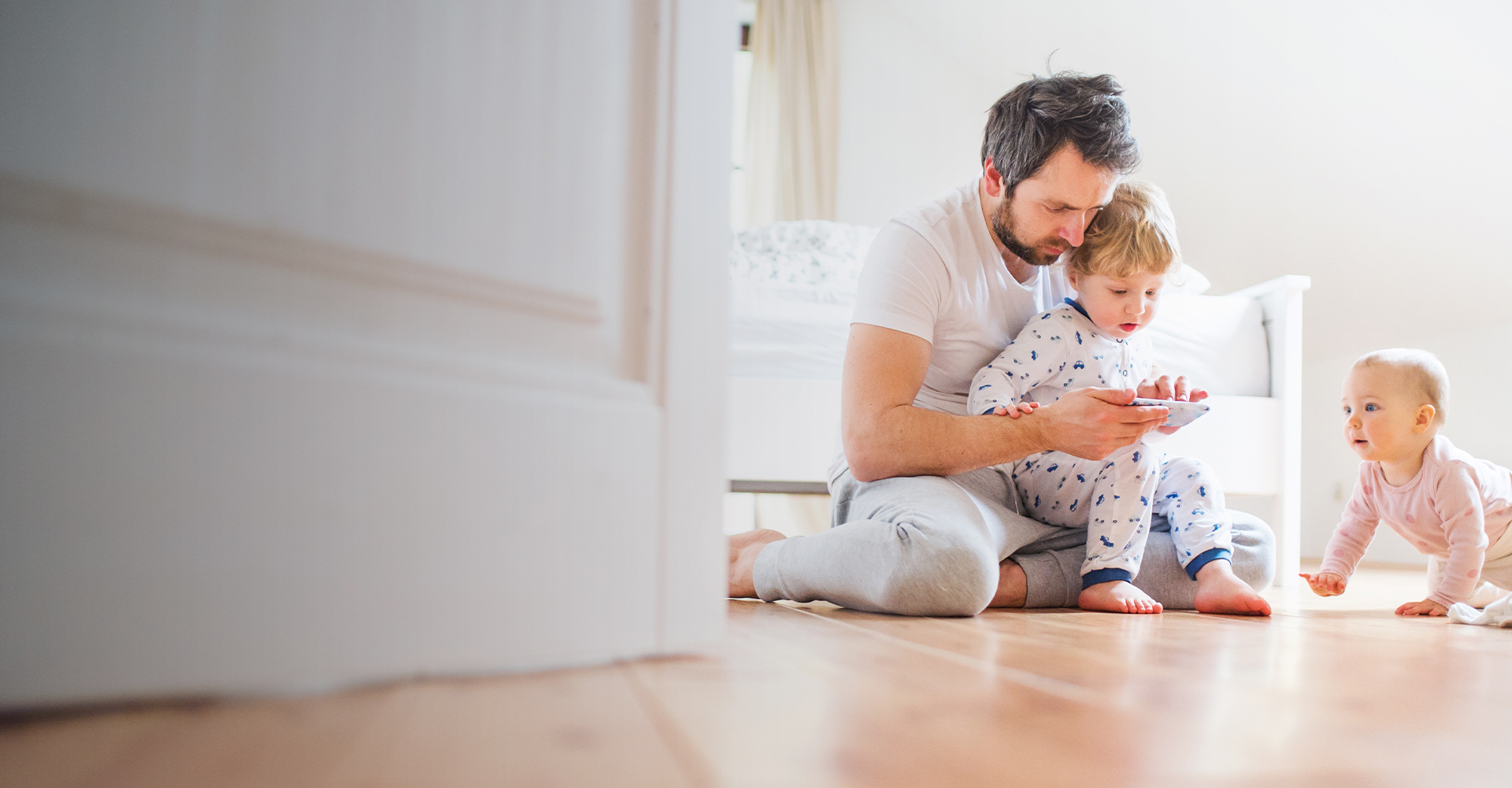 Mom and daughter playing with tablet on hard surface floors